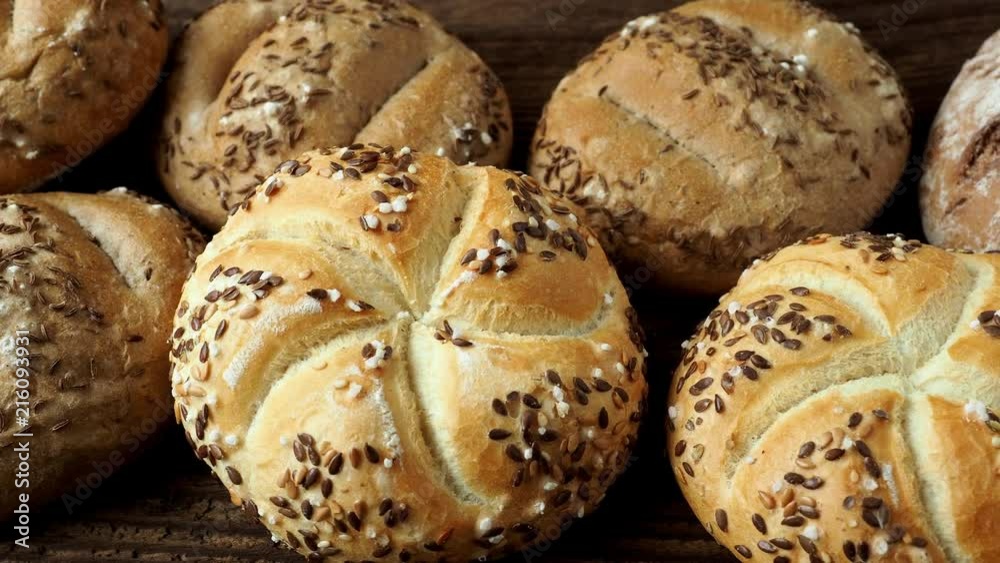 Different bread on a rustic wooden background. Bakery assortment of bread. Different bread on a rustic wooden background. Bakery assortment of bread.
