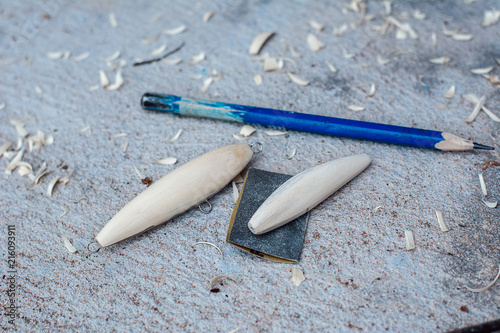 Hand made fishing lures. Making handcrafted fishing lures made of wood.