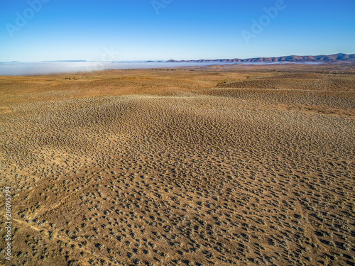 Rolling hills landscape with low morning clouds aerial view © Greg Brave