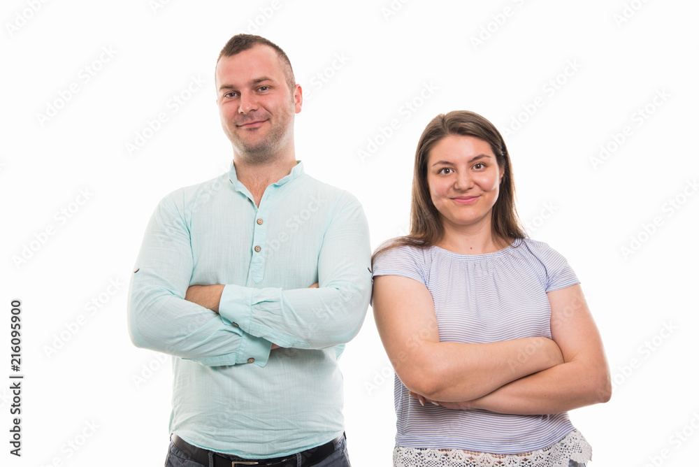 Portrait of young happy couple standing with arms crossed gesture Portrait of young happy couple standing with arms crossed gesture