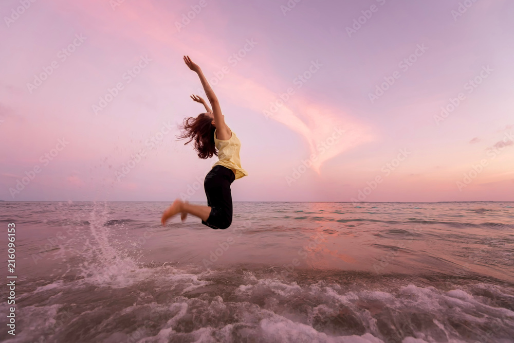 Asian pretty woman  is jumping and relax on beach. Positive emotions. Summer concept.