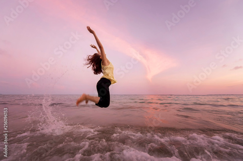 Asian pretty woman  is jumping and relax on beach. Positive emotions. Summer concept.