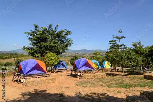 Tourist tents camping among meadow on mountain in Thailand