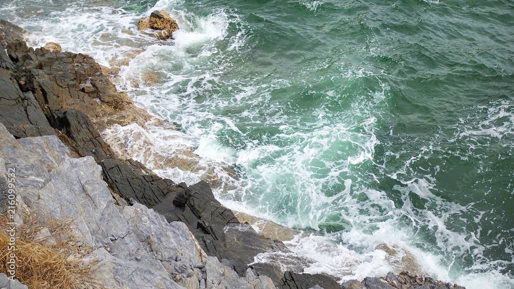 Beautiful tropical sea and steep rugged cliffs at Koh Sichang in Thailand, Space for text in template, Travel concept, Many tourists visit here, View for seascape, Top view Beautiful tropical sea and steep rugged cliffs at Koh Sichang in Thailand, Space for text in template, Travel concept, Many tourists visit here, View for seascape, Top view