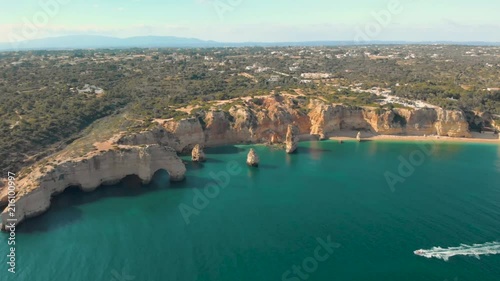 Panoramic aerial view of the Marinha beach with boat in Algarve, Portugal