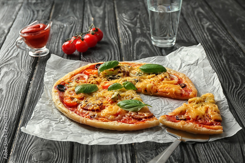 Tasty pizza on wooden table