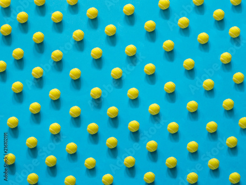 Yellow tennis ball patter on blue background © alexat25