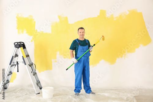 Male painter in uniform wit...