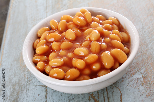 baked beans in tomato sauce in white  dish