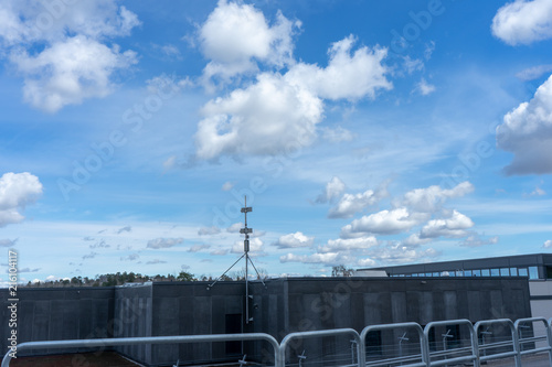 Clouds above a gray roof.