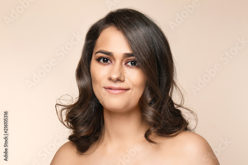 Portrait of young woman with beautiful makeup on color background. Professional cosmetics