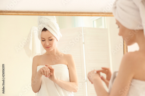Beautiful woman applying cr...
