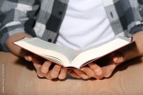 Young man reading book, clo...