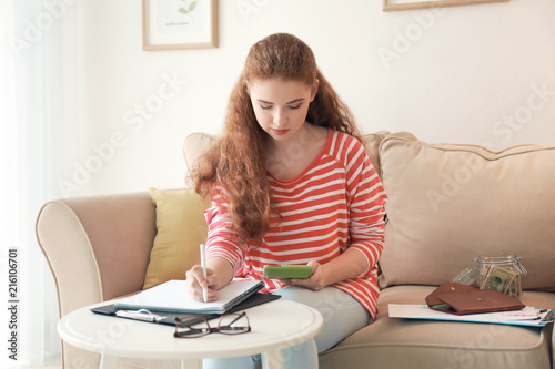 Young woman counting money ...