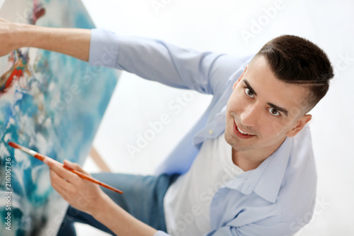 Male artist painting on can...