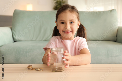 Little girl with glass jar ...