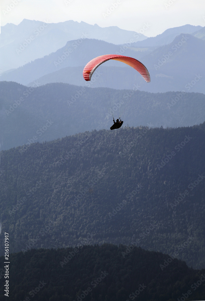 Paraglider in front of alpine mountain range Paraglider in front of alpine mountain range