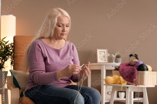 Mature woman sitting in arm...