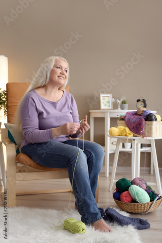 Mature woman sitting in arm...