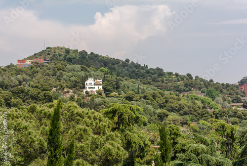 White Casa Trias on the hill, in the upper part of the park Guell. Casa Trias was designed by Juli Batllevell in 1906 and occupied by Marti Trias i Domenech, a lawyer and friend of Guell & Gaudi. photo