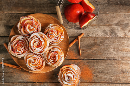 Tasty rose shaped apple pastry on wooden table photo