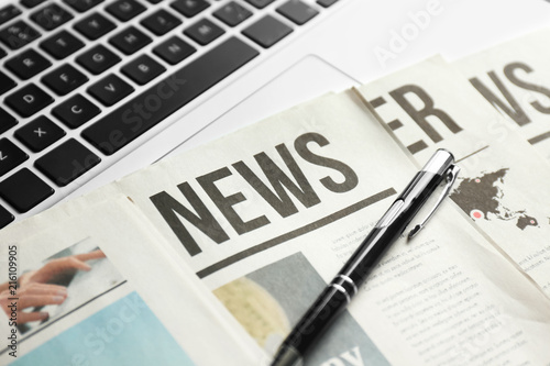Newspaper, pen and laptop, ...