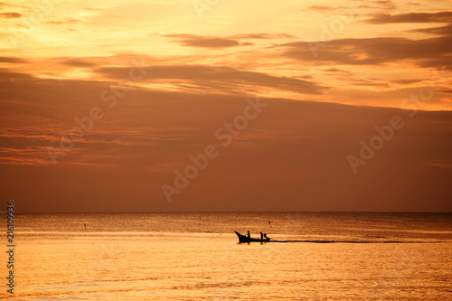Fishermen out fishing at sunrise in the sea, amidst the clouds and the sky is beautiful © pcbang