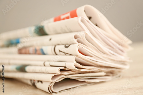 Folded newspapers wooden ta...