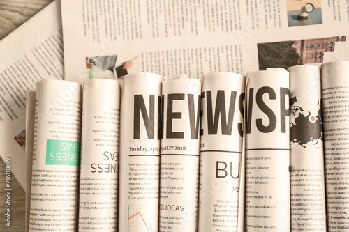 Many newspapers on table, t...