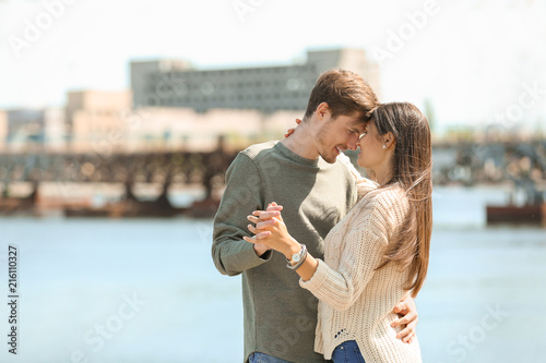 Happy young couple dancing outdoors