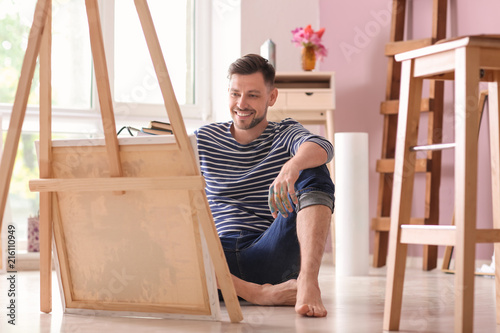 Male artist waiting for inspiration in workshop