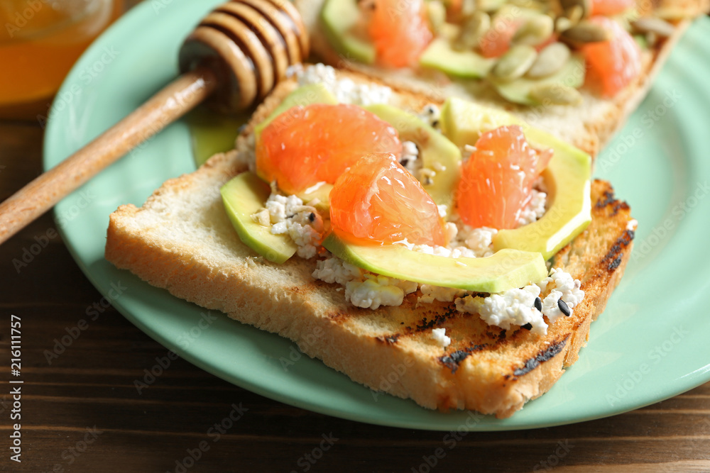 Plate with tasty toasts on wooden background, closeup Plate with tasty toasts on wooden background, closeup