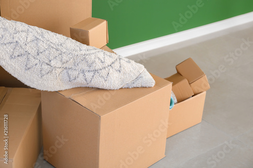 Carton boxes on floor in room. Moving house concept