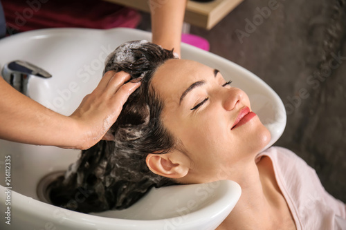 Young woman during washing of hair in beauty salon