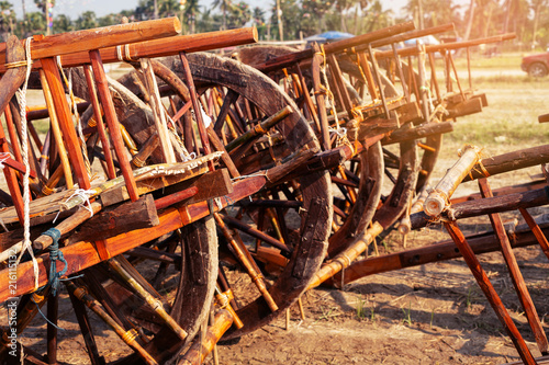 Thai cart..Wooden cow cart in petchaburi province Thailand standing by in paddy field at sunset.