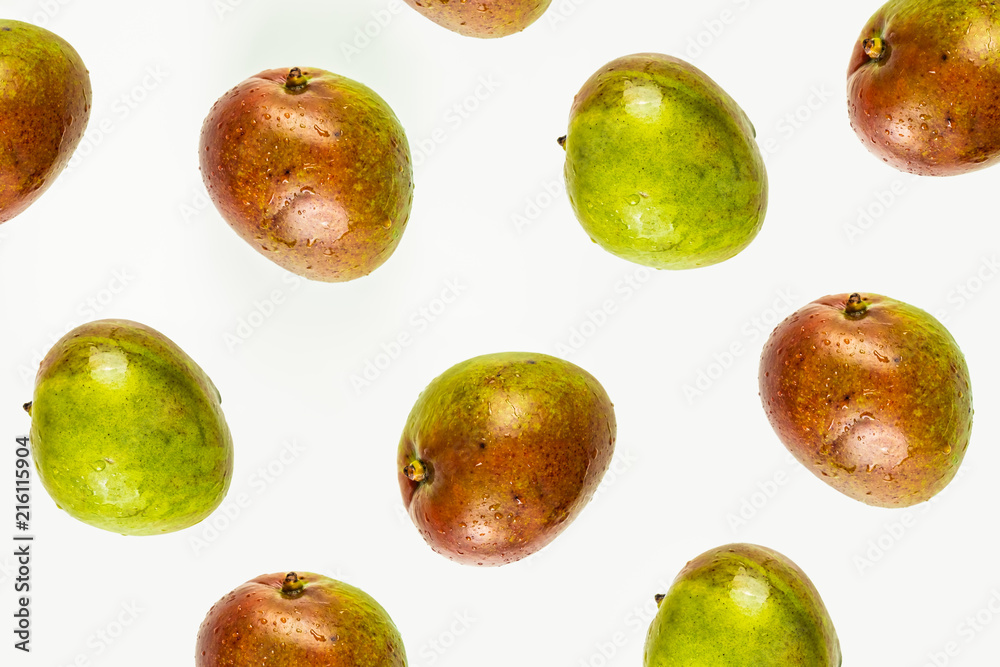 Isolated mango pattern or wallpaper on white background. Summer concept of fresh ripe whole mango fruits shot from above Isolated mango pattern or wallpaper on white background. Summer concept of fresh ripe whole mango fruits shot from above