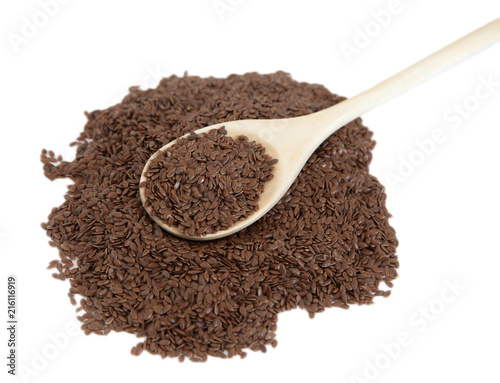 Flax seeds in a wooden spoon on white isolated background