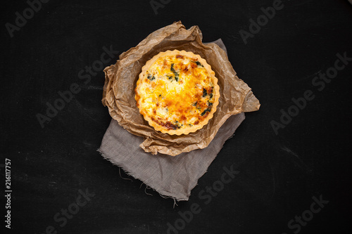 kish with onions and cheese on paper and fabric  