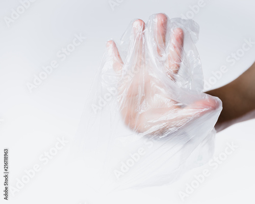male hand in transparent plastic bag making stop sign