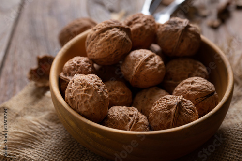Walnuts kernels in wooden bowl, Walnut healthy food Top view