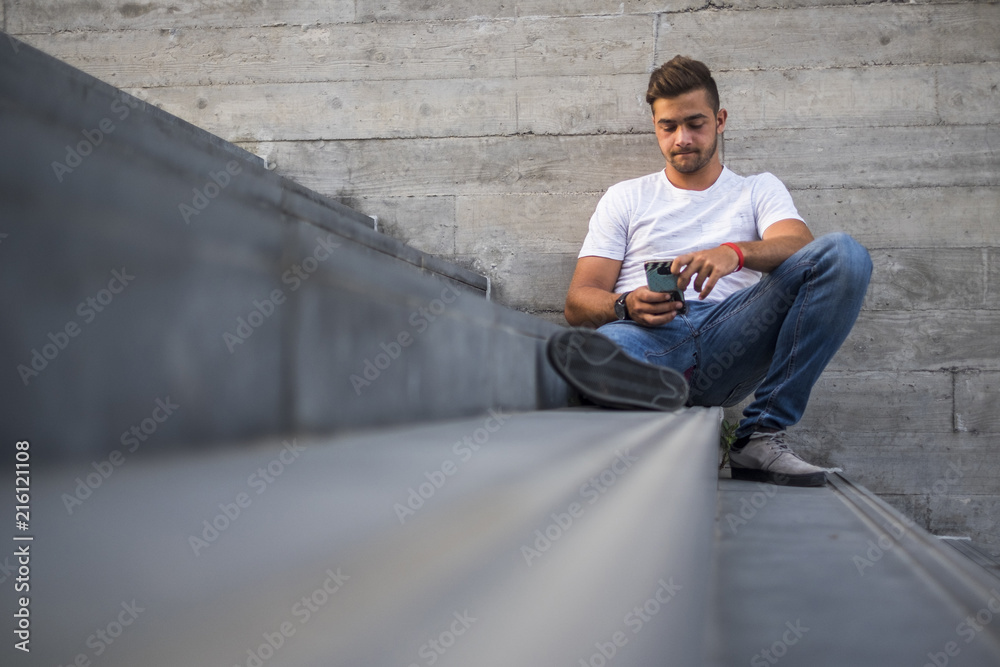 millennial generation next in deily leisure activity in the city using smartphone bored to connect and chat with friends alone too. internet people and social media disease