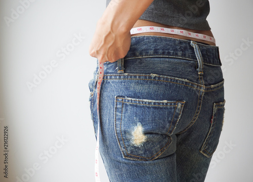 Fototapeta Naklejka Na Ścianę i Meble -  Slim woman in jeans, Health concept.