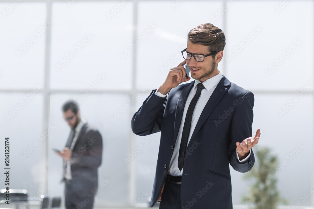 confident businessman talking on a mobile phone. confident businessman talking on a mobile phone.