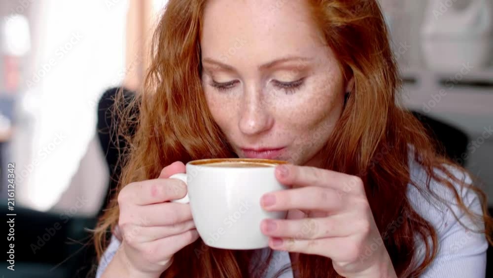 Young woman drinking coffee at cafe Young woman drinking coffee at cafe