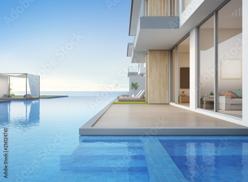 Luxury beach house with sea view swimming pool and empty terrace in modern design, Lounge chairs on wooden floor deck at vacation home or hotel - 3d illustration of contemporary holiday villa exterior