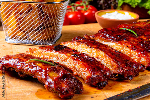 BBQ spare ribs from a charcoal grill photo