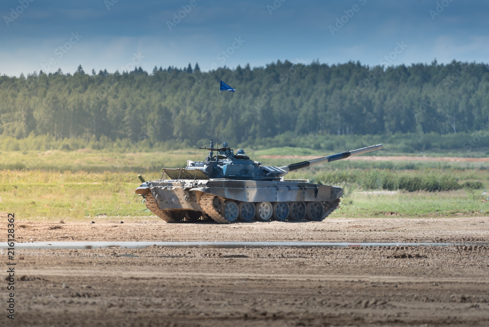Military armored tank driving in mud at the open field Military armored tank driving in mud at the open field
