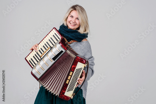 Konstfotografi Pretty young happy woman with accordion
