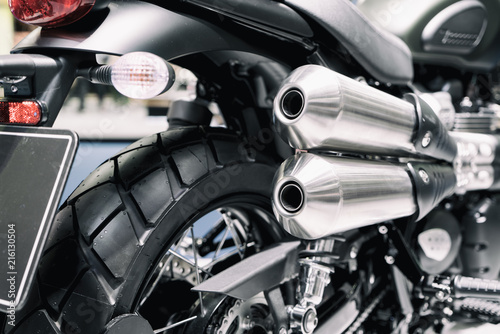 Close up shot of new motorcycle exhaust pipes. Rear view of a motorcycle with the focus on the chrome exhaust. © ake1150