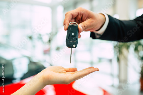 Hand over a car keys in dealership. Perfect choice. 
